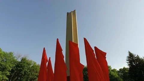 Red flags on background of blue sky in windy weather slow motion Stock Footage 123984266
