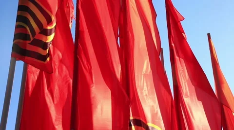 Red flags flutter on a wind against the sky Stock Footage 49921504