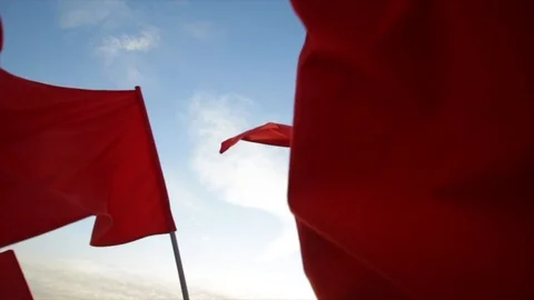 Red flags is waving against blue sky. 库存影片 103701161