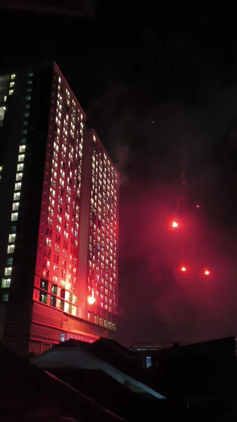 Red flares lighting up over urban residential area Stock Footage 340256146