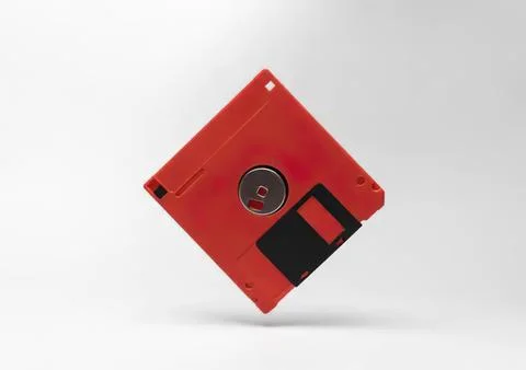 Red floppy disk with black label on white background Stock Photos
