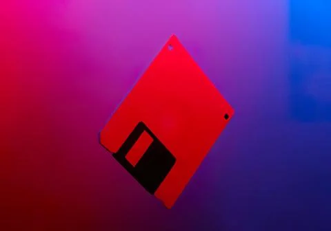 Red floppy disk icon on colorful gradient background Stock Photos