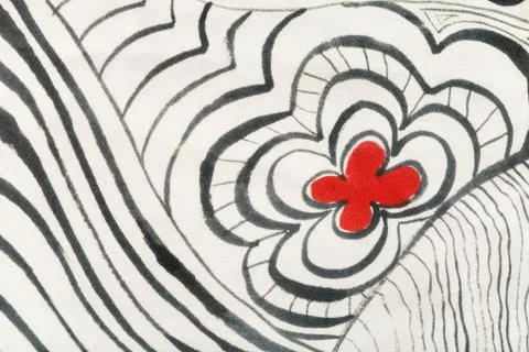 Red flower between black lines on white cloth Stock Photos