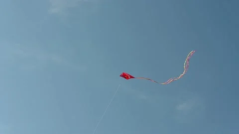 Red flying kite with a long tail Stock Footage 145763017