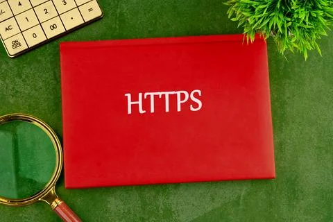 A red folder labeled HTTPS sits on a green surface, symbolizing the importanc Foto stock