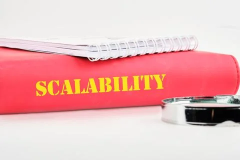 A red folder titled Scalability sits on a white surface, accompanied by a spi Stock Photos