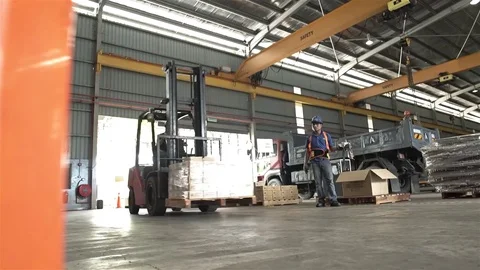 Red Fork Lift Carrying Out Product From Warehouse Stock Footage