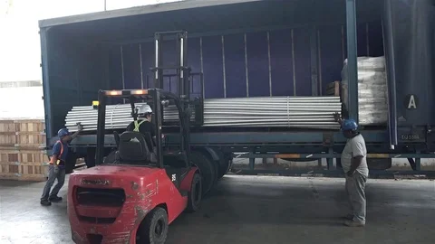 Red Fork Lift Loading Roud Duct Pipes In Blue Truck - Front Angle Stock Footage 79083336