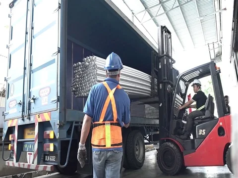 Red Fork Lift Loading Roud Duct Pipes In Blue Truck Stock Footage 79083339