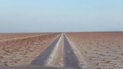 Red four wheel drive passing the salt lake on sunrise tc01 Stock Footage 102223679
