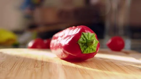 Red fresh pepper on board close-up. Preparing salad and vegetables for Stock Photos