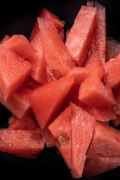 Red fresh watermelon slices, triangular fresh fruit snack on black backround Stock Photos