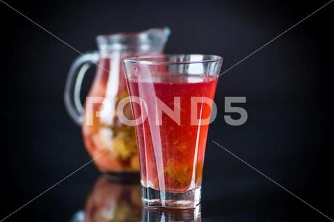 Red fruit compote in a decanter with a glass Stock Photos
