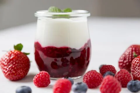 Red fruit compote with mint leaves and fruit Stock Photos