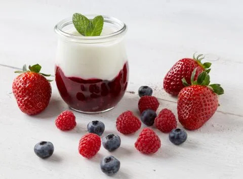 Red fruit compote with mint leaves and fruit Stock Photos