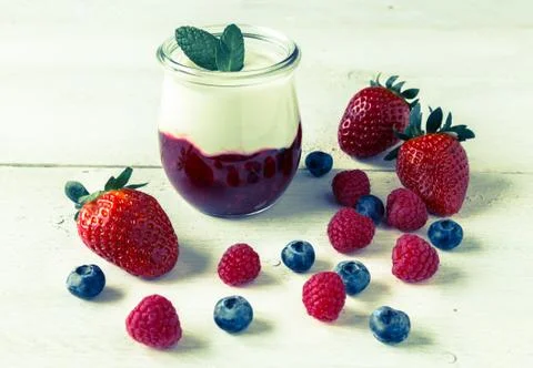 Red fruit compote with mint leaves and fruit Stock Photos