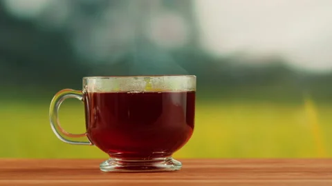Red fruit tea in glass cup on a wooden table. Hibiscus tea ceremony process Stock Footage 191094885