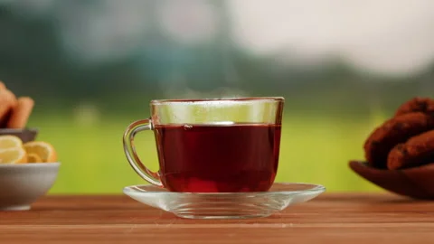 Red fruit tea in glass cup on a wooden table. Hibiscus tea ceremony process Stock Footage 191095053