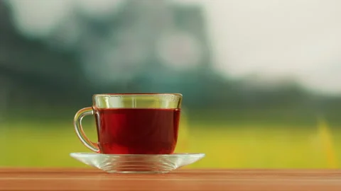Red fruit tea in glass cup on a wooden table. Hibiscus tea ceremony process Stock Footage 191095095