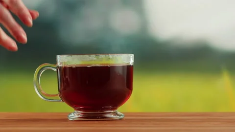 Red fruit tea in glass cup on a wooden table. Hibiscus tea ceremony process Stock Footage 191095202