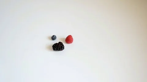 Red fruits on white background Видео 76982770