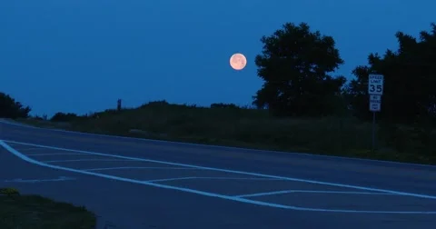  Red full moon  and Car Passes - 4k Stock Footage 64997174
