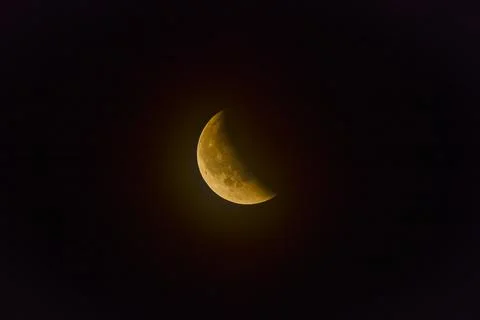 Red full moon during the eclipse seen at half-coverage Stock Photos