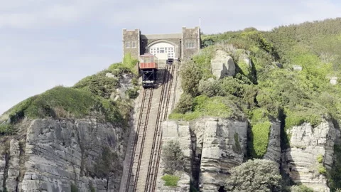 Red funicular cliff railway ascending 4K Stock Footage 338135385