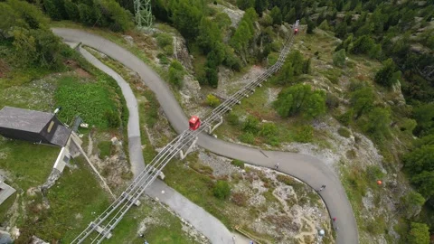 Red funicular to Emosson Dam base in Swiss Alps, dramatic alpine scenery Stock Footage 317767532