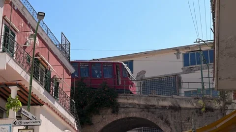 Red Funicular Tram Crossing Bridge Through Capri Street Buildings Stock Footage 345320355