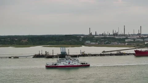 Red Funnel Ferry over refinery and Esso Oil Terminal, Southampton, Hampshire, UK Stock-Footage 316142434