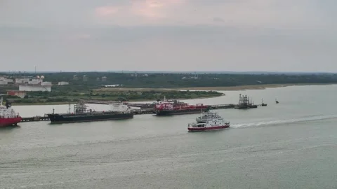 Red Funnel Ferry over refinery and Esso Oil Terminal, Southampton, Hampshire, UK Stock-Footage 316142476