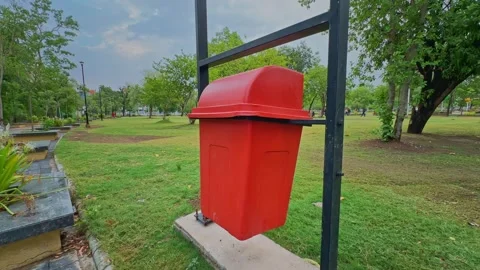Red Garbage Bin in Public Park Push In Camera Shot Stock Footage 338003350