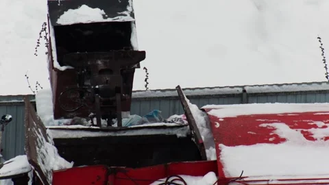 Red garbage truck compacting waste in snow-covered street during winter day. Stock Footage 326751303