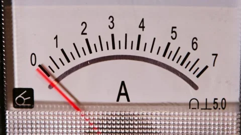 Red gauge needle rises across industrial scale on close-up meter face with Stock Footage 345435006