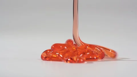 Red gel flowing on the table and slowly lay down on the flatness. Detailed view. Stock Footage 123984490