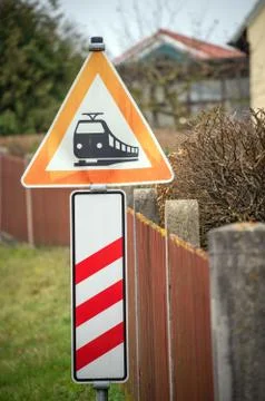 Red german triangle warning sign for incoming train Stock Photos