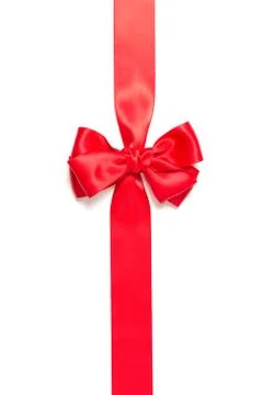 Red gift bow and vertically crossed red ribbon isolated on white background. Stock Photos