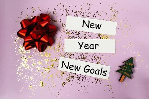 Red gift bow, glitter, and festive decorations surround text cards stating New Stock Photos