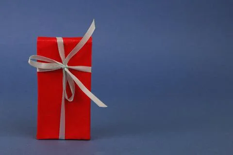 Red gift box on blue background. Stock Photos