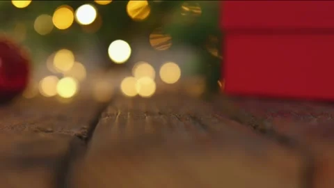 Red gift box Christmas tree garland defocused blurred lights wooden background 動画素材 164932395
