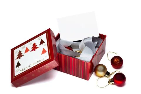 Red gift box with Christmas trees and "Merry Christmas" text Stock Photos