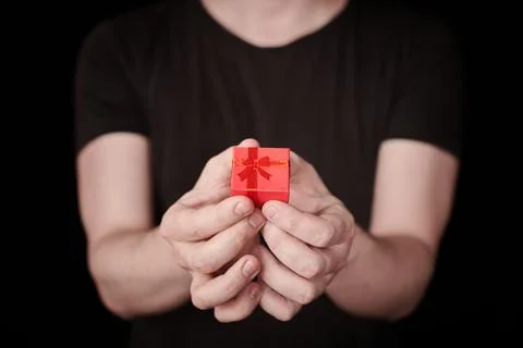 Red gift box in hand on St. Valentine day Stock Photos