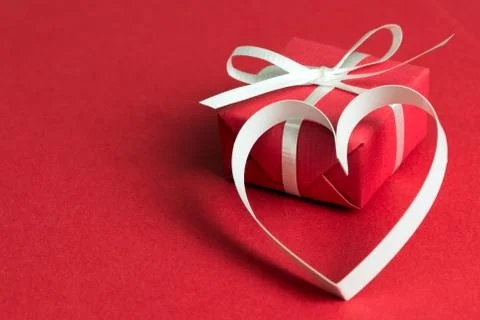 Red gift box with a heart shape symbol Stock Photos