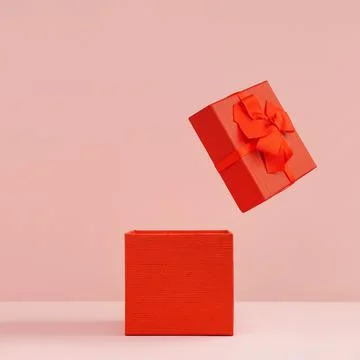 Red gift box with open lid on pink background Stock Photos