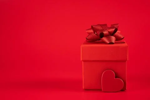 Red gift box with a red bow and heart Stock Photos