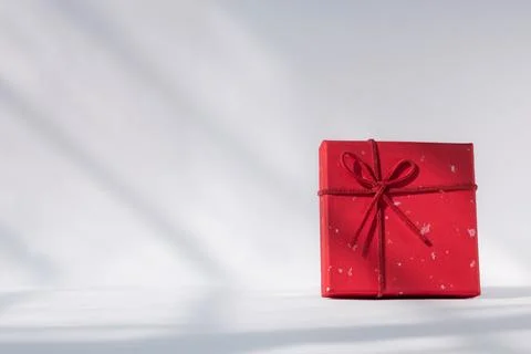 Red gift box with red bow on white background. Holiday greeting card Stock Photos