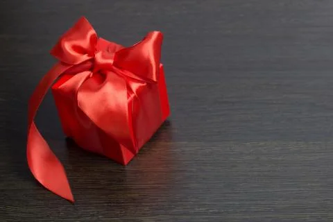 Red gift box with red satin ribbon top view Stock Photos