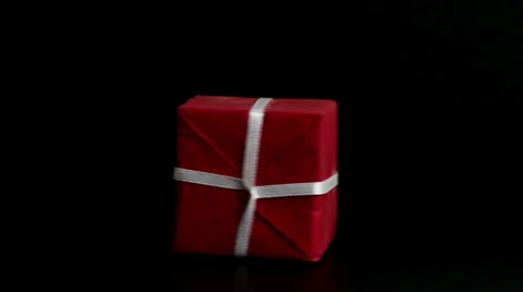 Red Gift Box with White Ribbon, spinning - Low key studio shot Stock Footage 34606046
