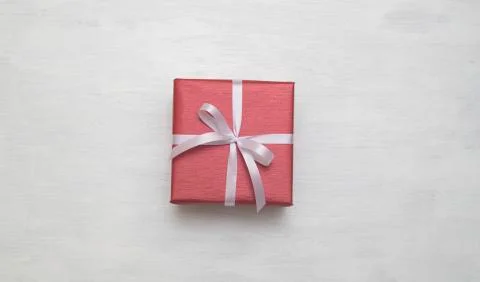 Red gift box with white ribbon isolated on white background. Stock Photos